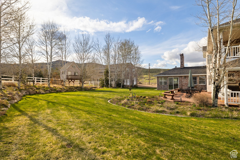 View of yard with a patio area and fence