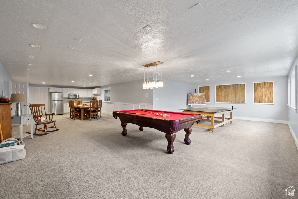Recreation room with wainscoting, light carpet, a textured ceiling, recessed lighting, and pool table