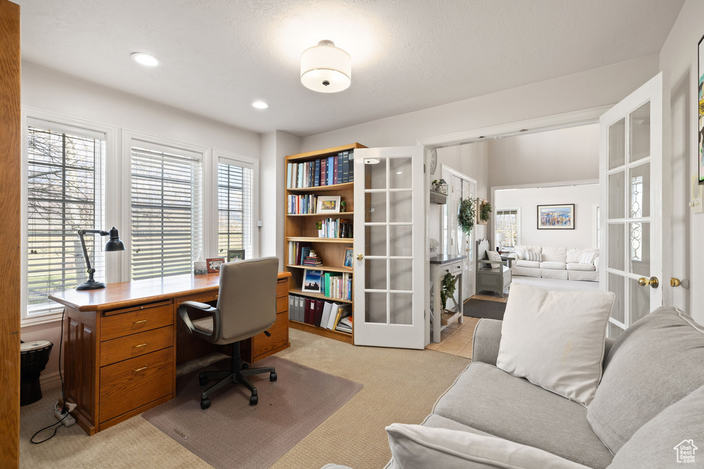 Home office featuring light carpet, french doors, and recessed lighting