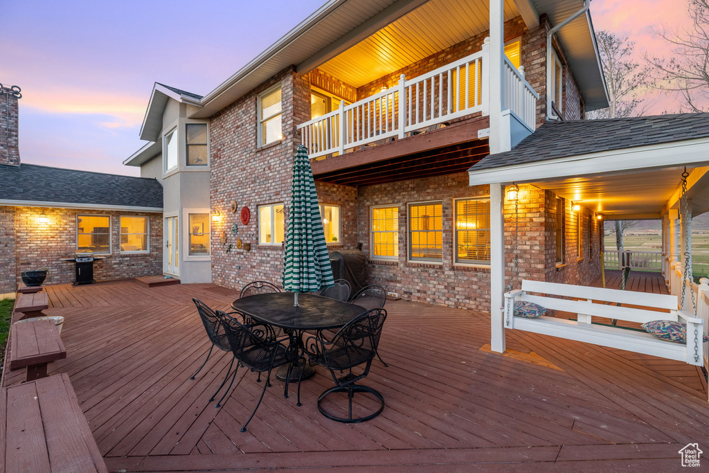 Deck at dusk with outdoor dining space