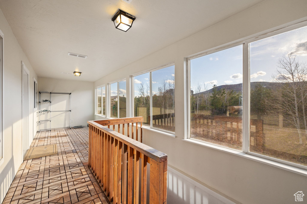 Unfurnished sunroom with visible vents and a mountain view
