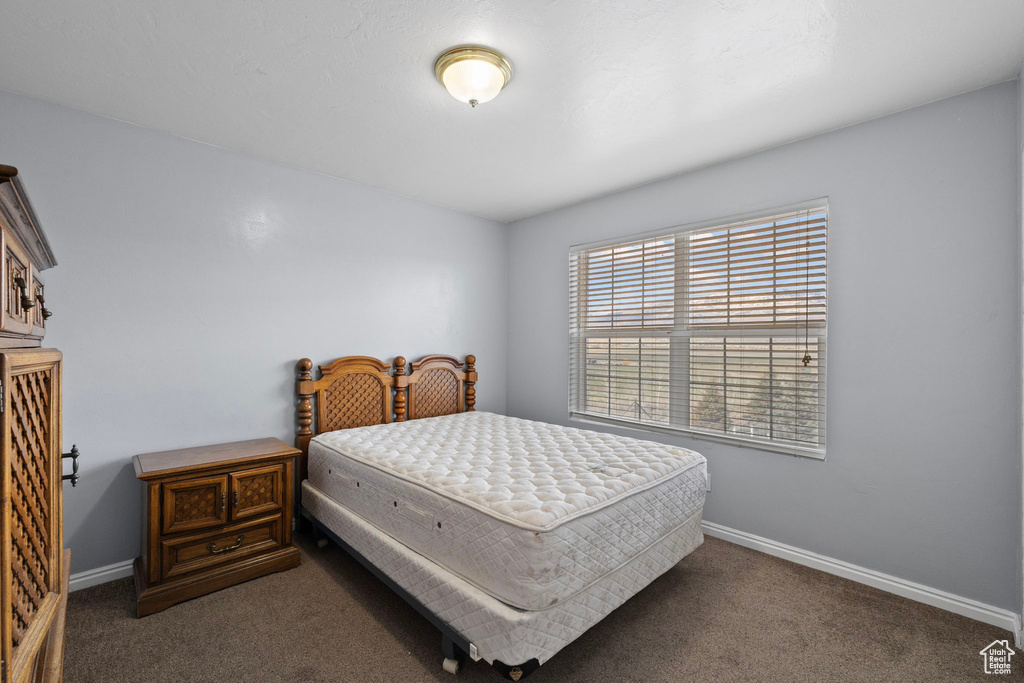 Bedroom with baseboards and carpet