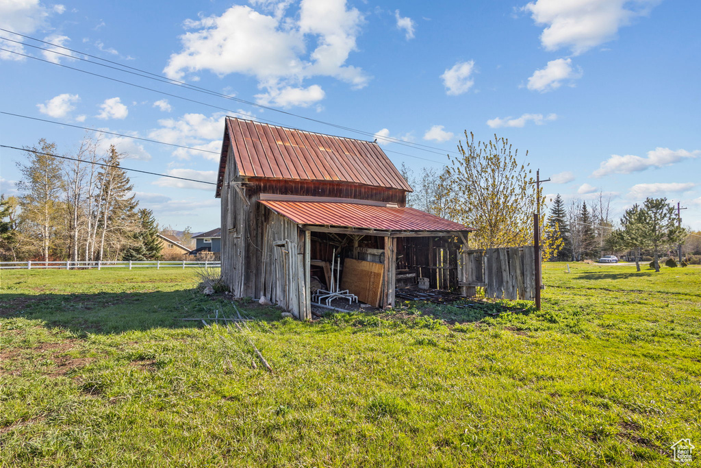 View of outdoor structure with fence and an outdoor structure