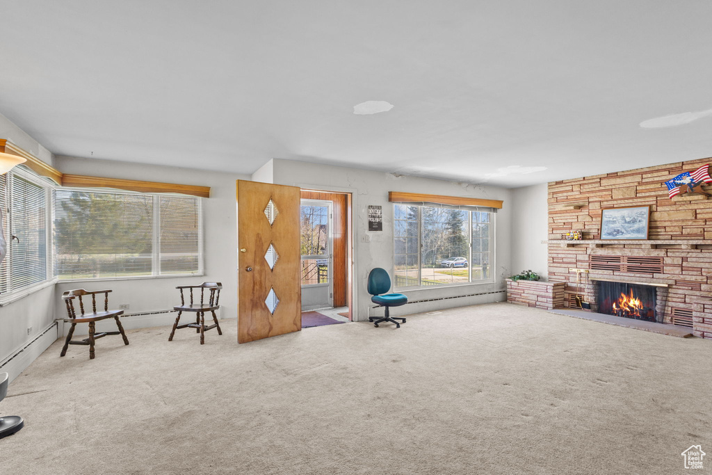 Unfurnished room featuring carpet floors, baseboards, and a fireplace