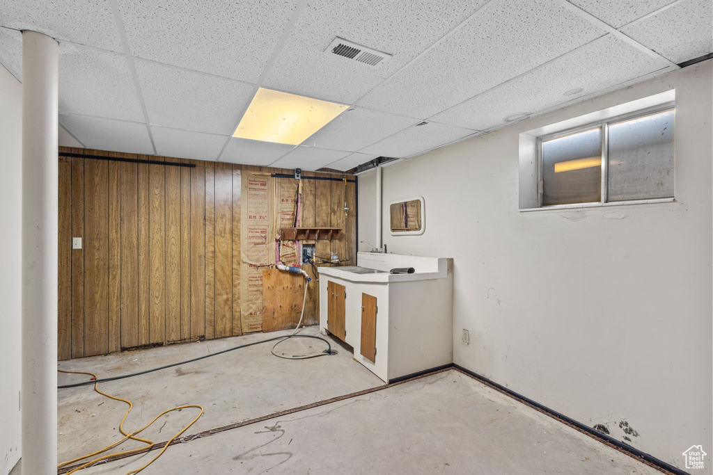 Finished below grade area with visible vents and a paneled ceiling