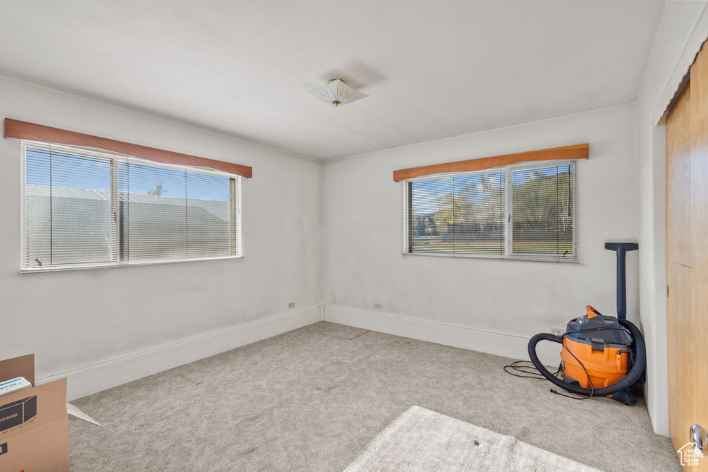 Spare room featuring carpet floors and baseboards
