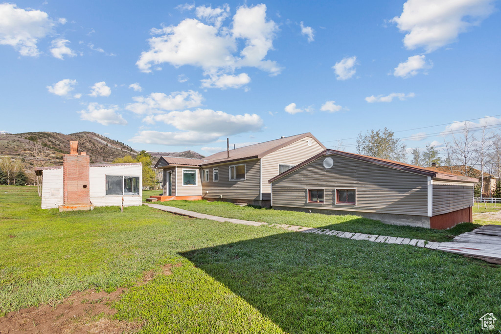 Rear view of property featuring a yard