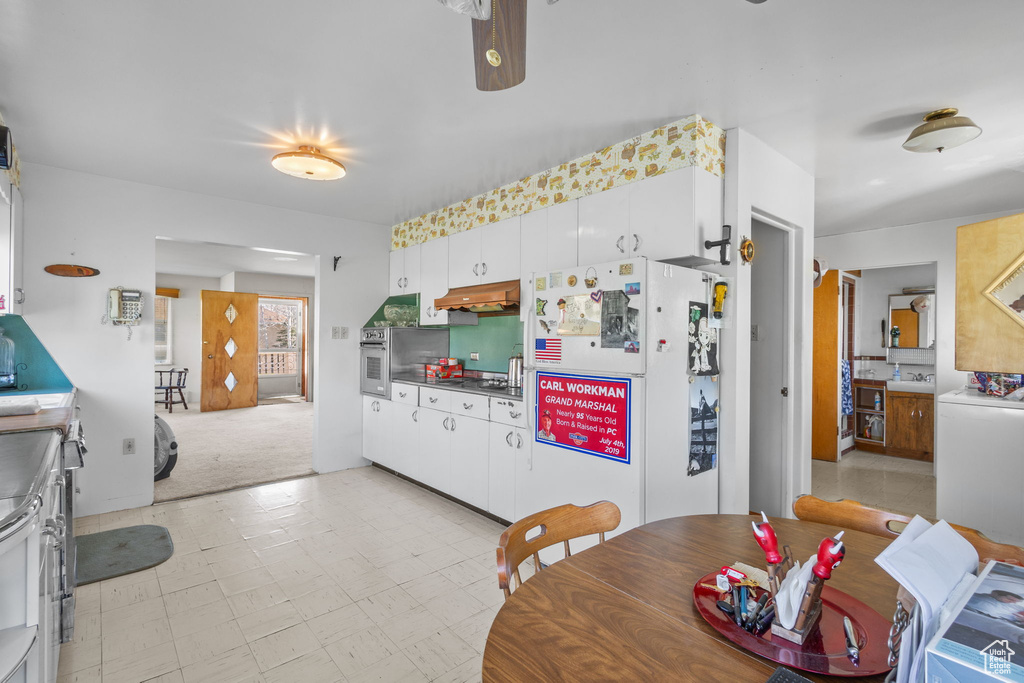 Dining space with ceiling fan and light floors