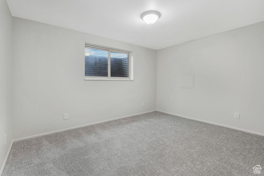 Empty room with carpet floors and baseboards