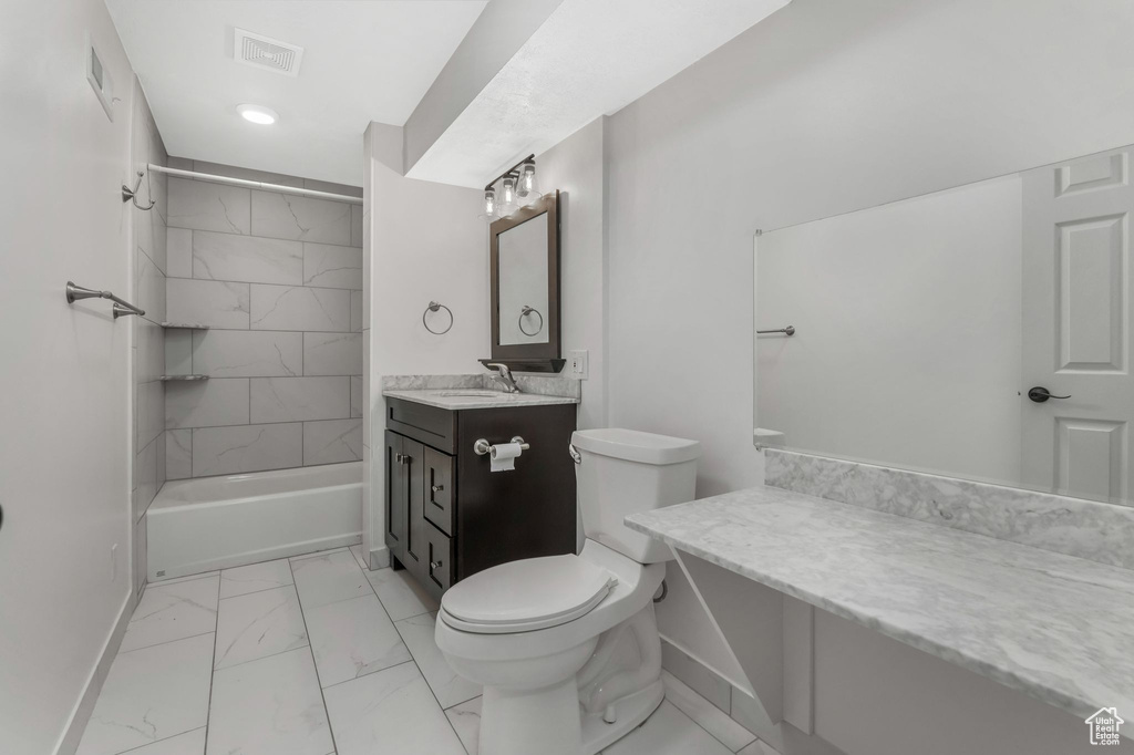 Full bath featuring visible vents, vanity, marble finish floor, toilet, and baseboards
