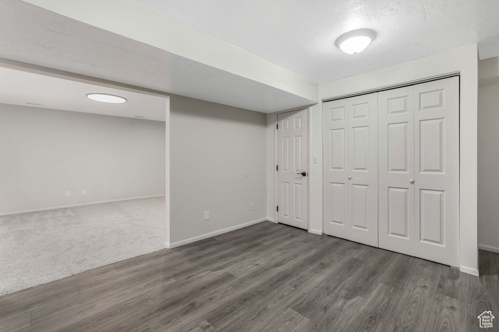 Finished below grade area featuring baseboards and wood finished floors