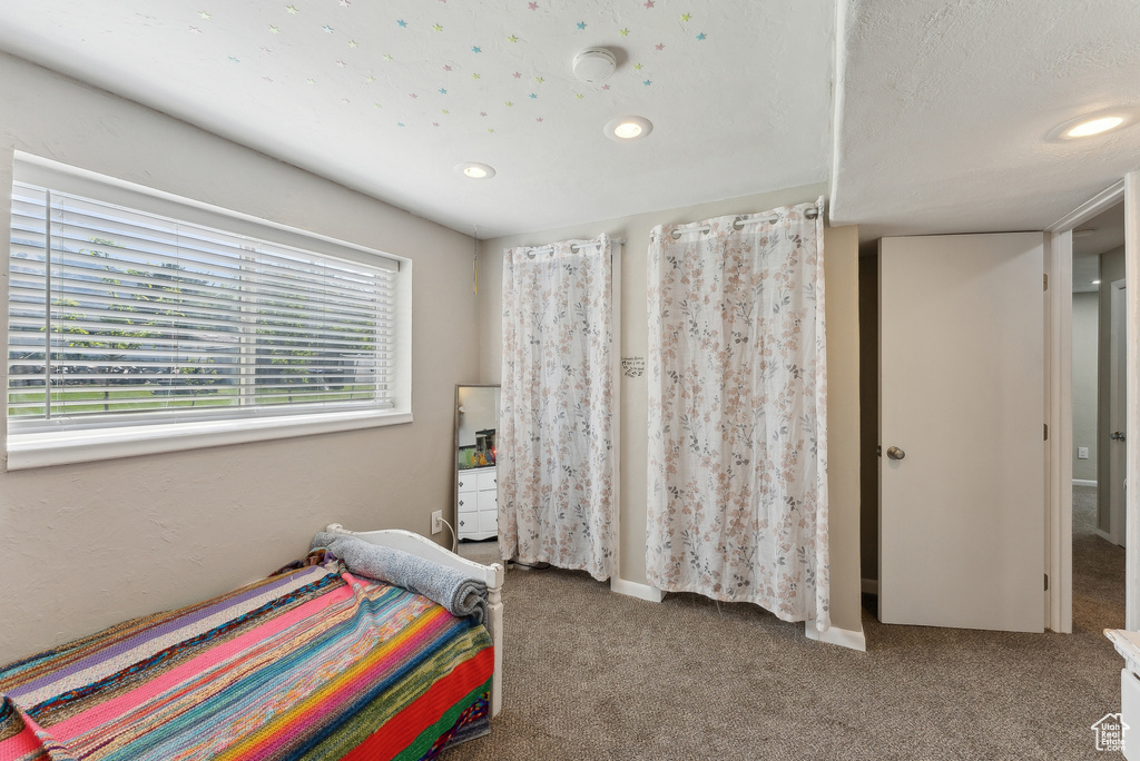Carpeted bedroom with recessed lighting