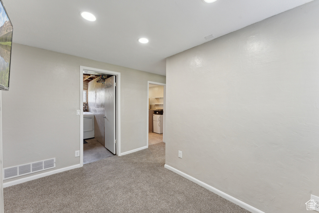 Interior space featuring carpet, washer / clothes dryer, recessed lighting, baseboards, and visible vents