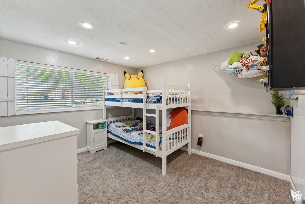 Bedroom featuring light colored carpet, recessed lighting, baseboards, and visible vents