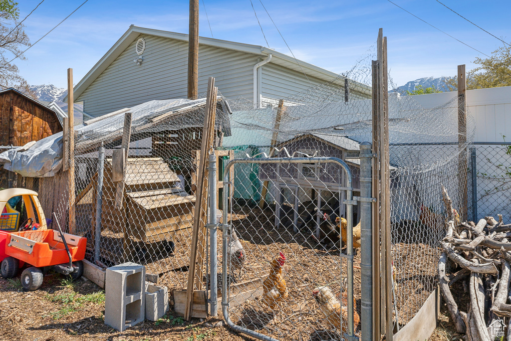 View of home\'s exterior featuring fence, exterior structure, and an outbuilding