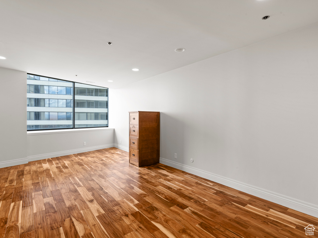 Spare room featuring baseboards, recessed lighting, and wood finished floors