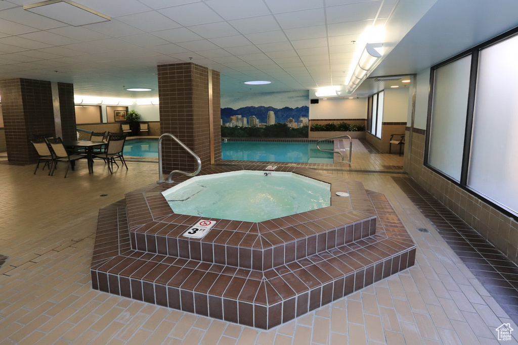 View of pool with an indoor in ground hot tub