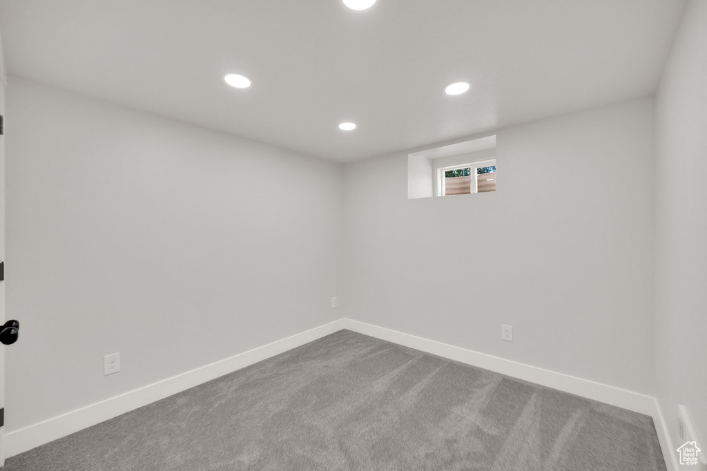 Below grade area featuring recessed lighting, baseboards, and dark colored carpet