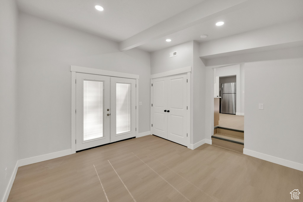 Entrance foyer with baseboards, french doors, and recessed lighting