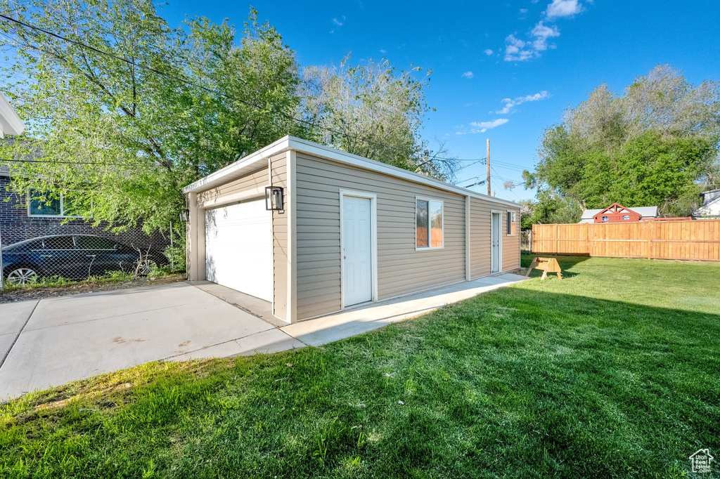 Detached garage featuring fence