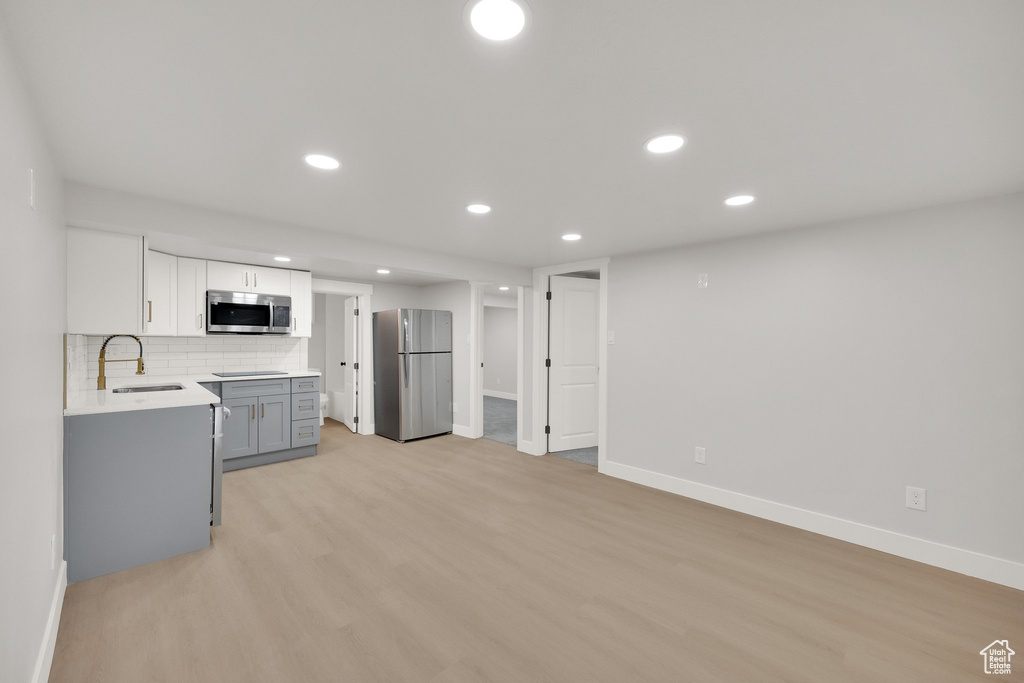 Kitchen featuring baseboards, a sink, appliances with stainless steel finishes, and recessed lighting