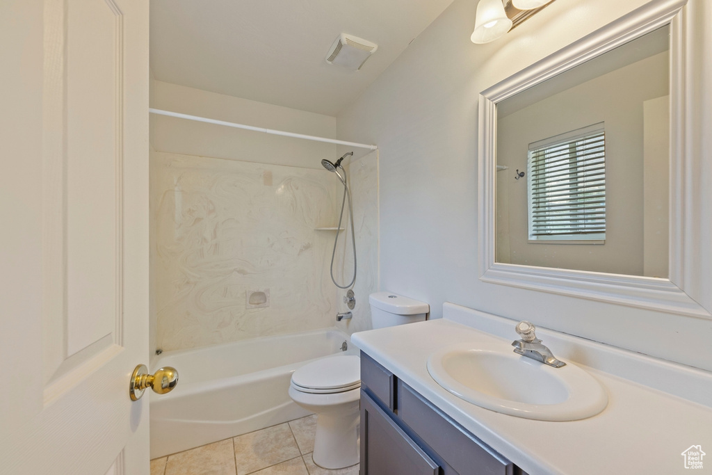 Full bath featuring shower / bathtub combination, toilet, tile patterned floors, and vanity