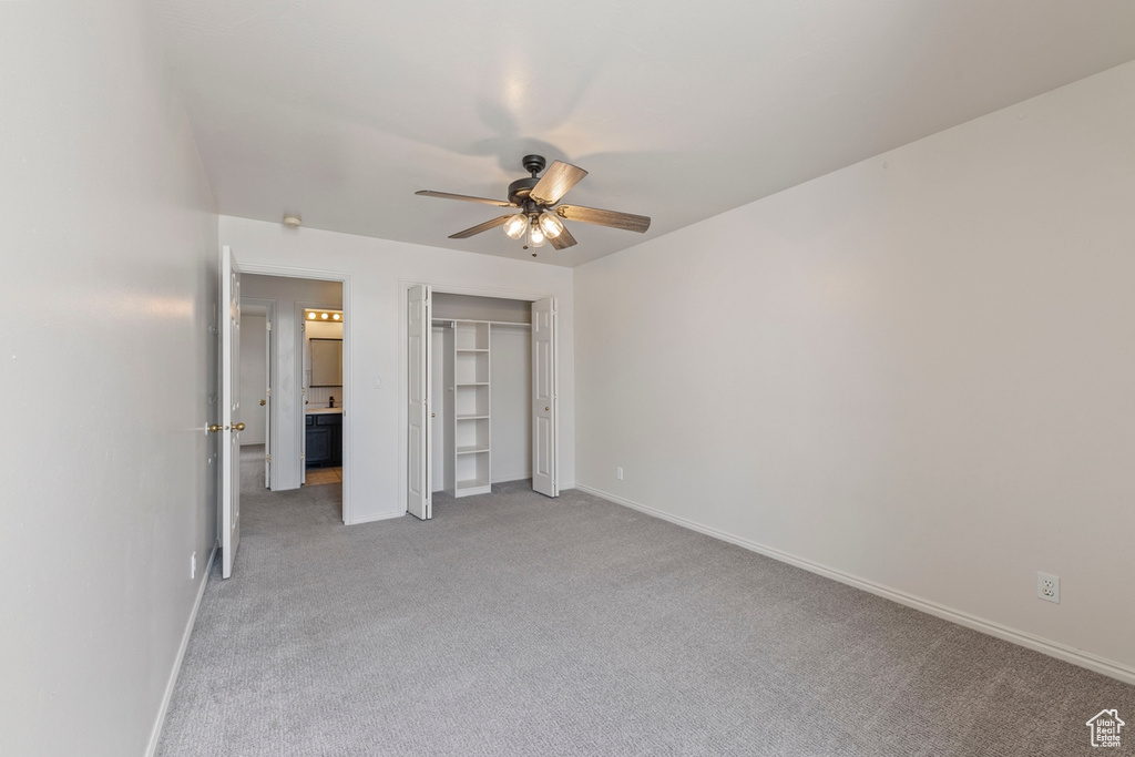 Unfurnished bedroom with baseboards, a ceiling fan, a closet, and light carpet