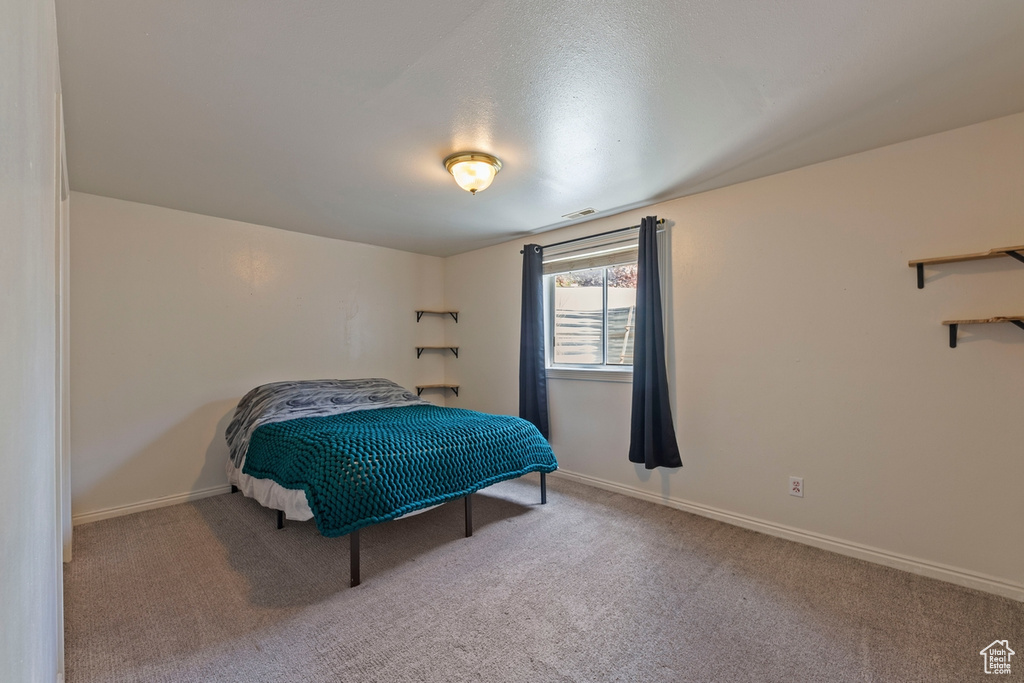 Carpeted bedroom featuring baseboards