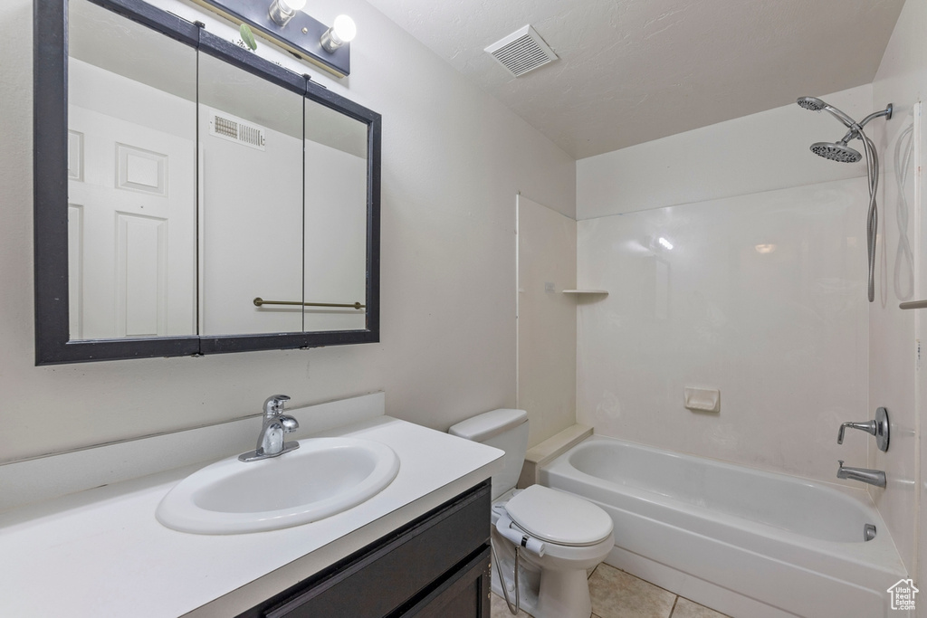 Bathroom featuring vanity, shower / bathtub combination, toilet, and visible vents