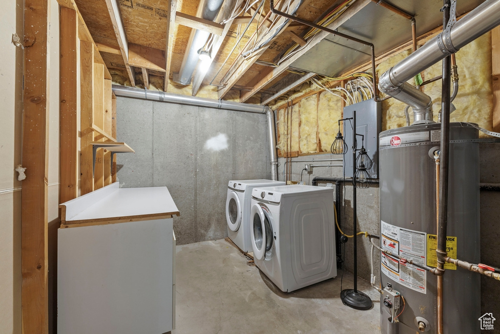 Laundry area with laundry area, gas water heater, and washing machine and dryer
