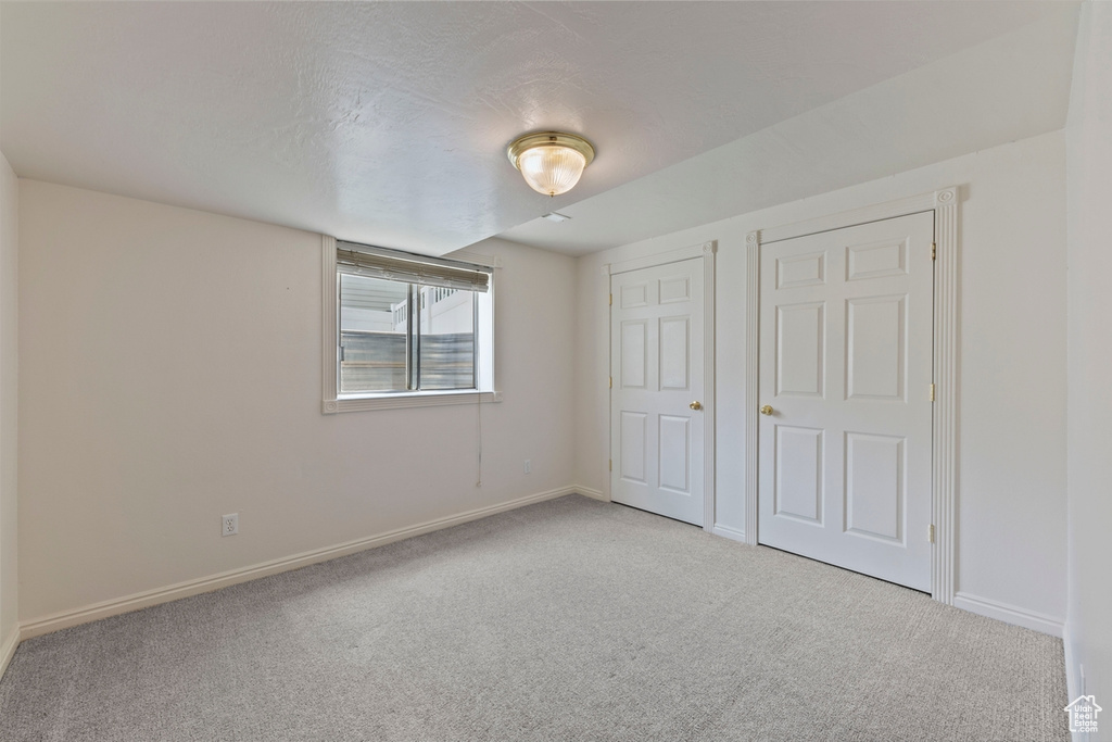 Unfurnished bedroom with baseboards and carpet flooring