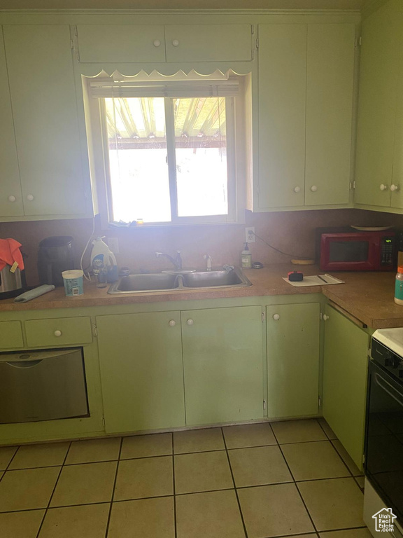 Kitchen featuring a sink, light countertops, plenty of natural light, and light tile patterned flooring