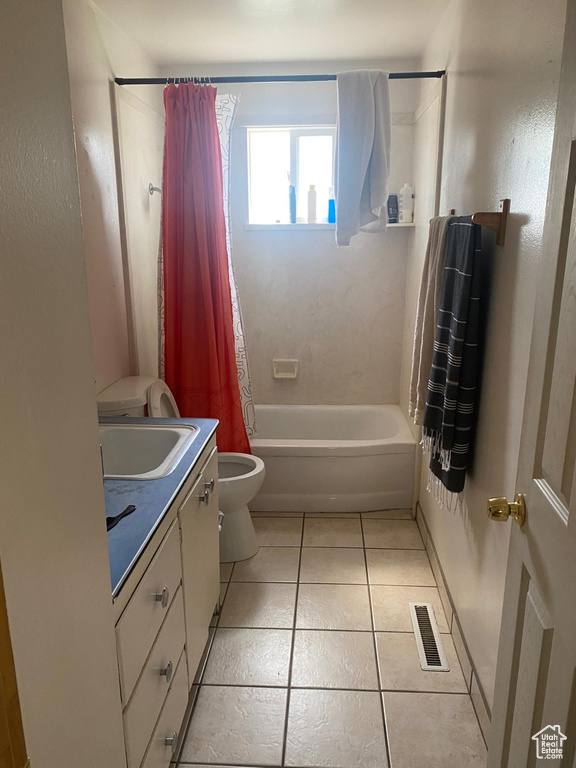 Full bath featuring visible vents, tile patterned flooring, vanity, toilet, and shower / bath combo with shower curtain