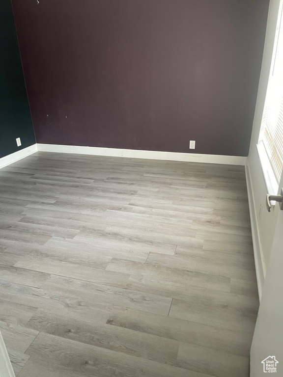 Empty room with baseboards and wood finished floors