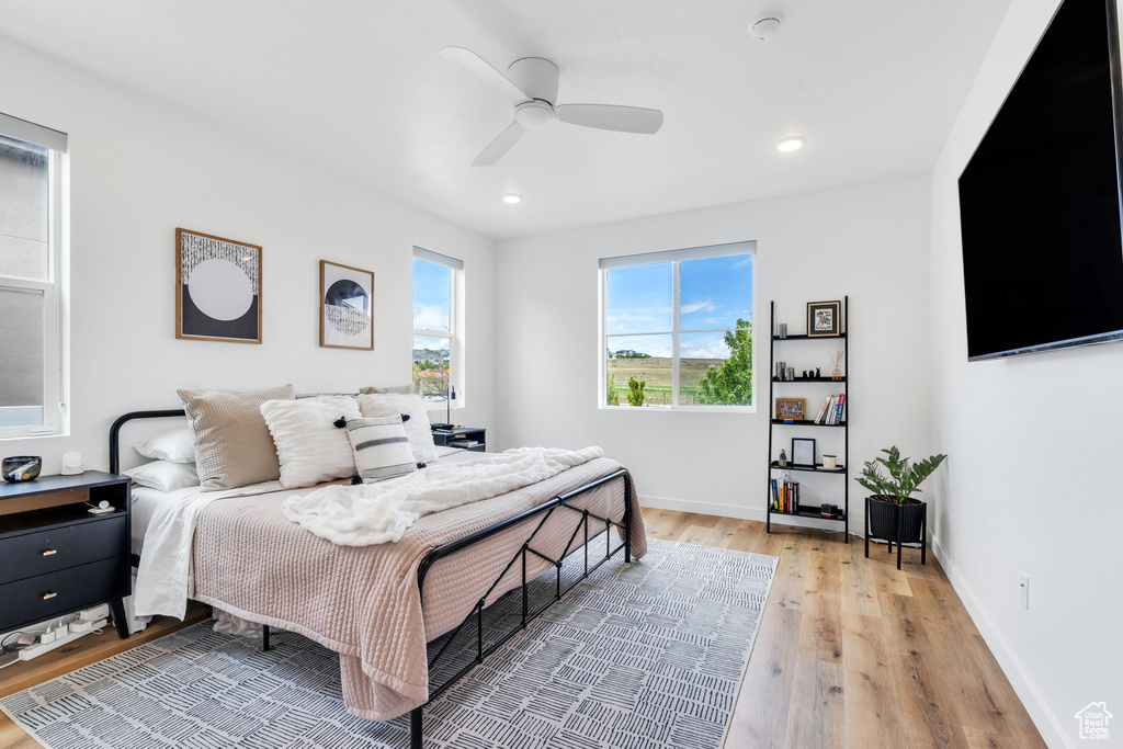 Bedroom with a ceiling fan, baseboards, recessed lighting, and light wood-type flooring