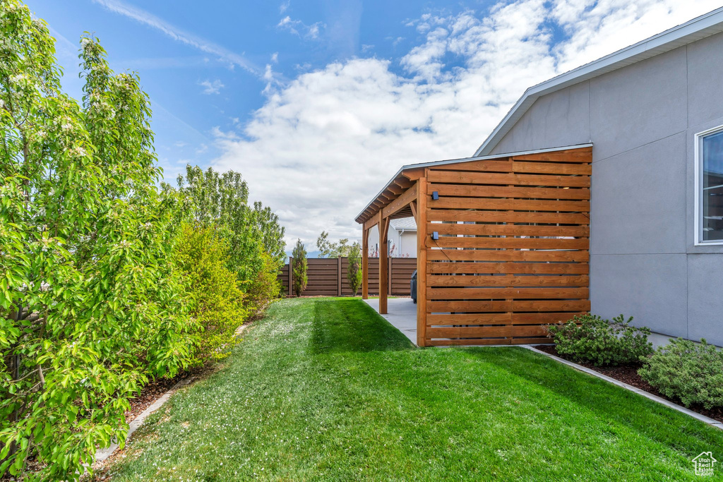 View of yard with fence and a patio