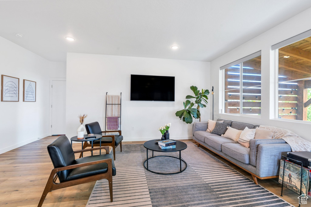 Living area with recessed lighting, wood finished floors, and a wealth of natural light