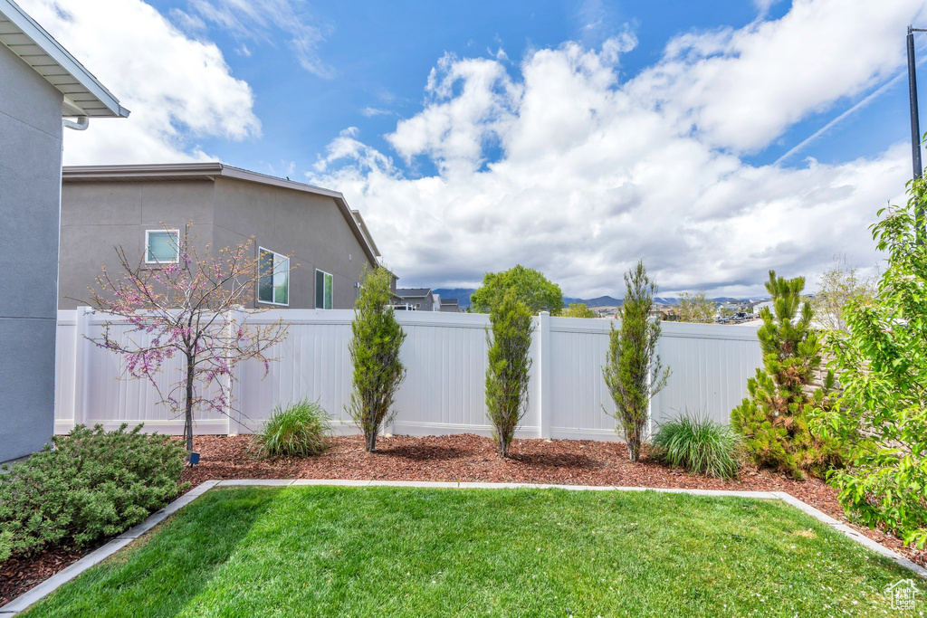 View of yard featuring fence