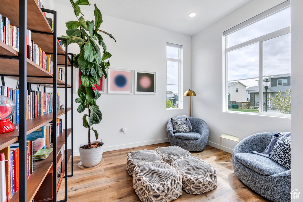 Living area featuring baseboards, recessed lighting, and wood finished floors