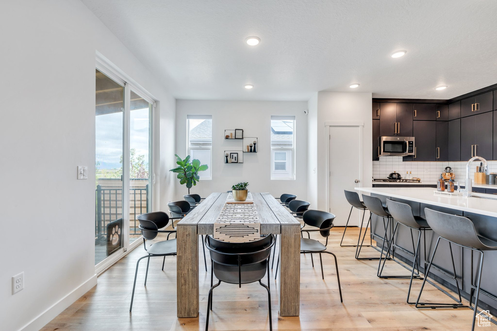 Dining space with recessed lighting and light wood finished floors