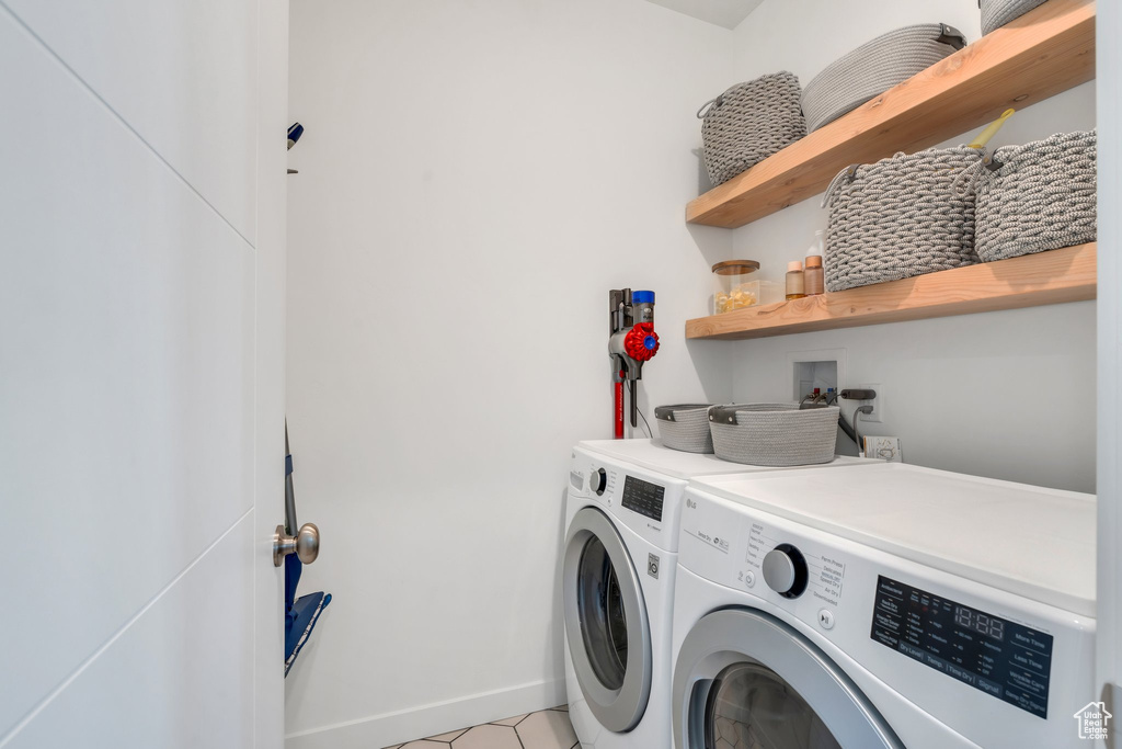 Laundry room featuring baseboards, laundry area, and washer and clothes dryer
