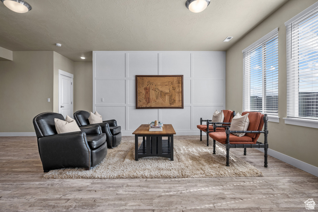 Living area featuring baseboards and wood finished floors