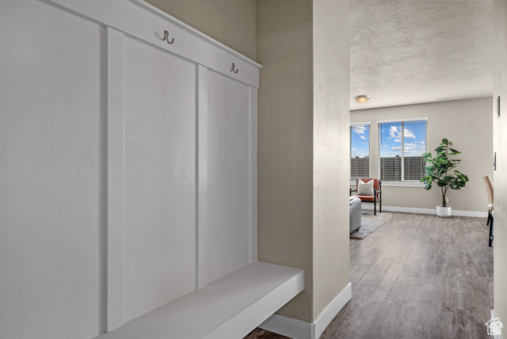 Mudroom with baseboards and wood finished floors