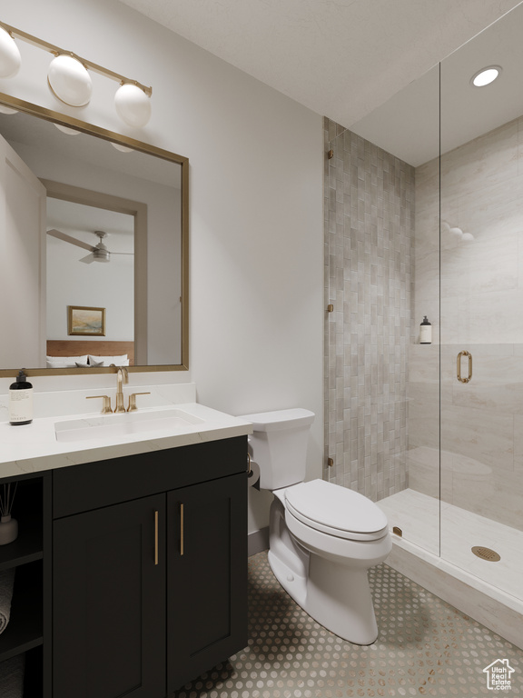 Full bathroom featuring vanity, toilet, a ceiling fan, recessed lighting, and a stall shower