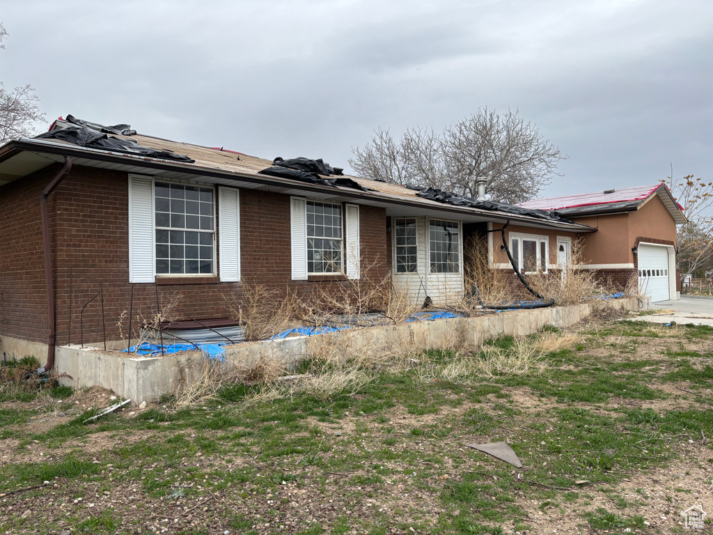 View of front of property with brick siding and a garage