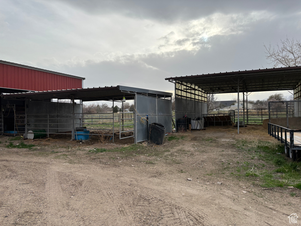 View of outbuilding featuring an outdoor structure, an exterior structure, and a detached carport