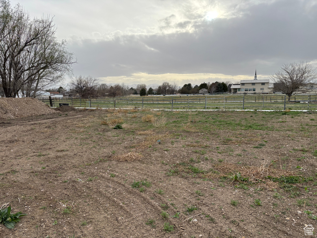 View of yard featuring fence and a rural view