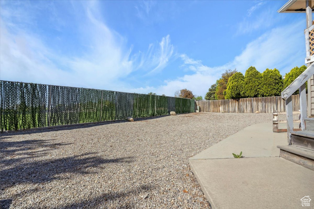 View of yard with a fenced backyard and a patio area