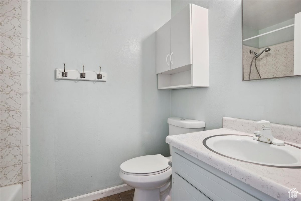 Full bath featuring toilet, tile patterned floors, and vanity