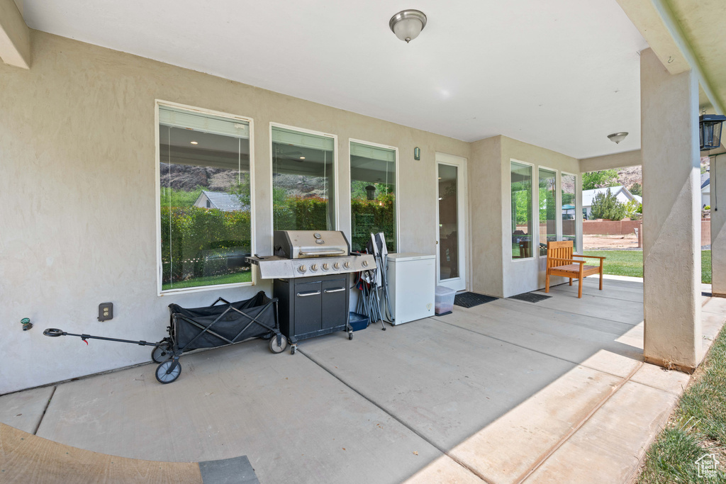 View of patio with a grill